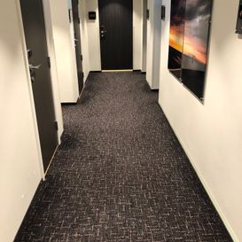 Grått teppegulv i korridor